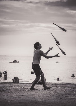 A black & white image of a Juggler on the Beach